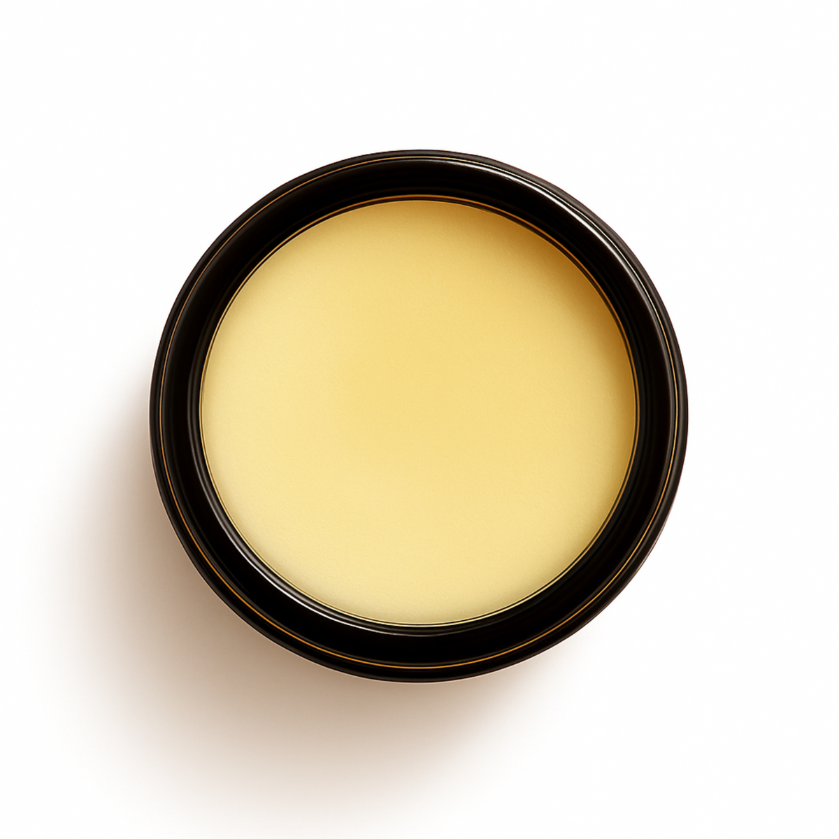 Top-down view of an open amber glass jar filled with smooth, pale yellow Deep Restore Tallow Balm, designed to deeply nourish and repair dry or sensitive skin.