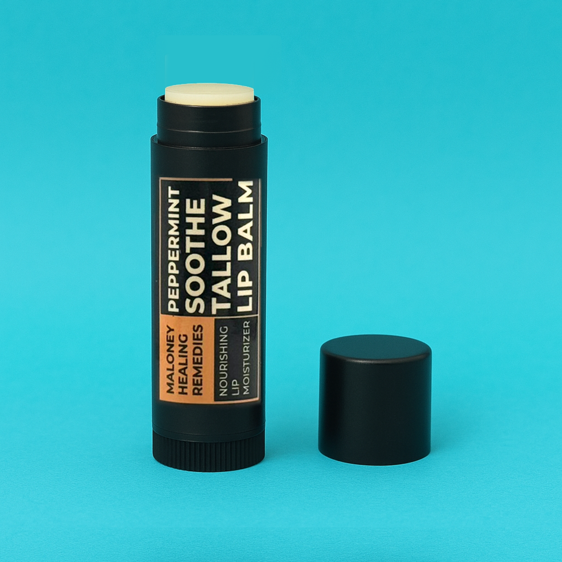Open tube of best tallow lip balm with black cap off, shown against a turquoise background.