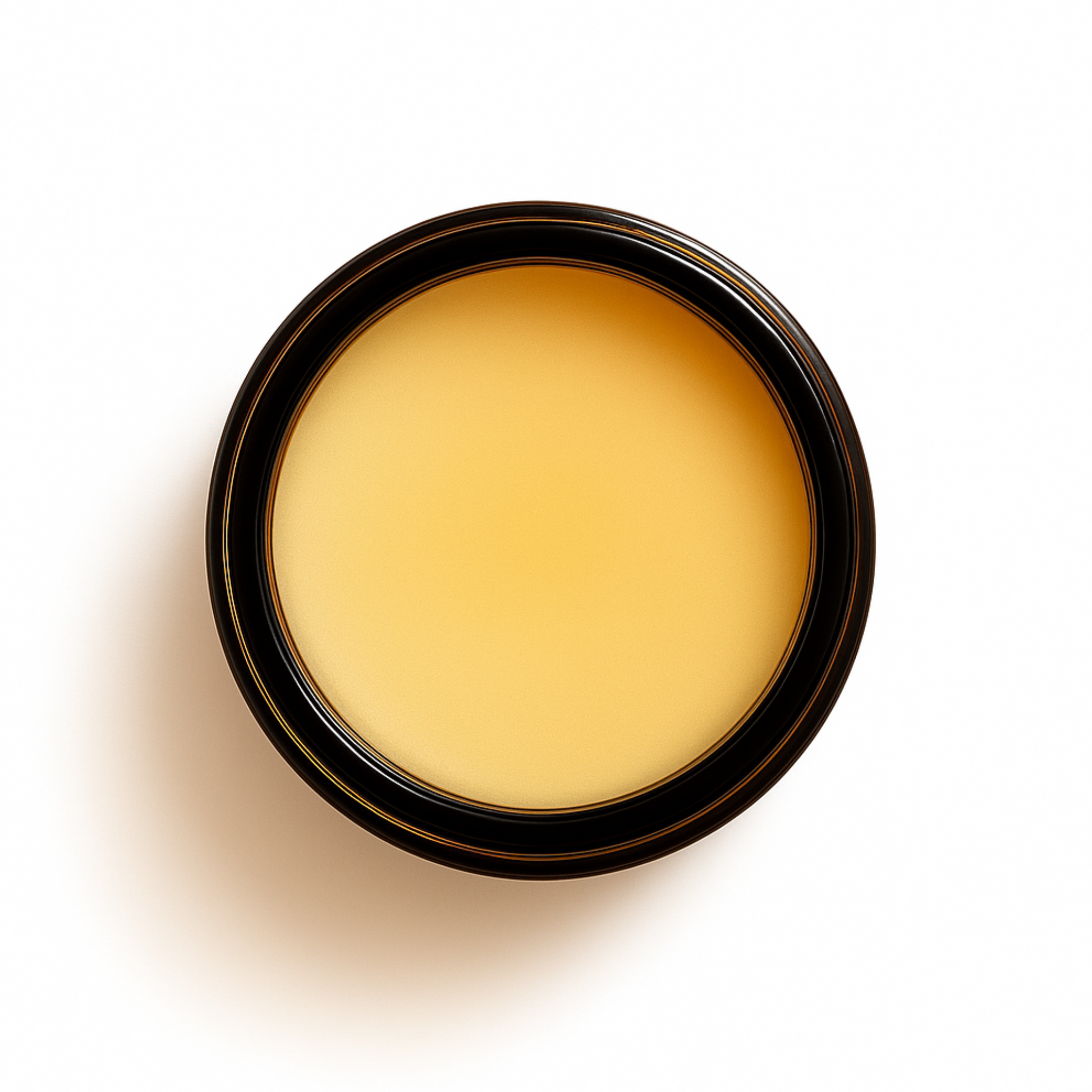 Top-down view of an open amber glass jar filled with smooth, golden tallow balm. Radiance Rose & Sandalwood Tallow Balm designed to deeply hydrate and calm sensitive skin.
