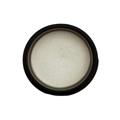 Top view of an open jar of Sedona Solar Shield, showing smooth, off-white tallow-based mineral balm with a creamy texture.