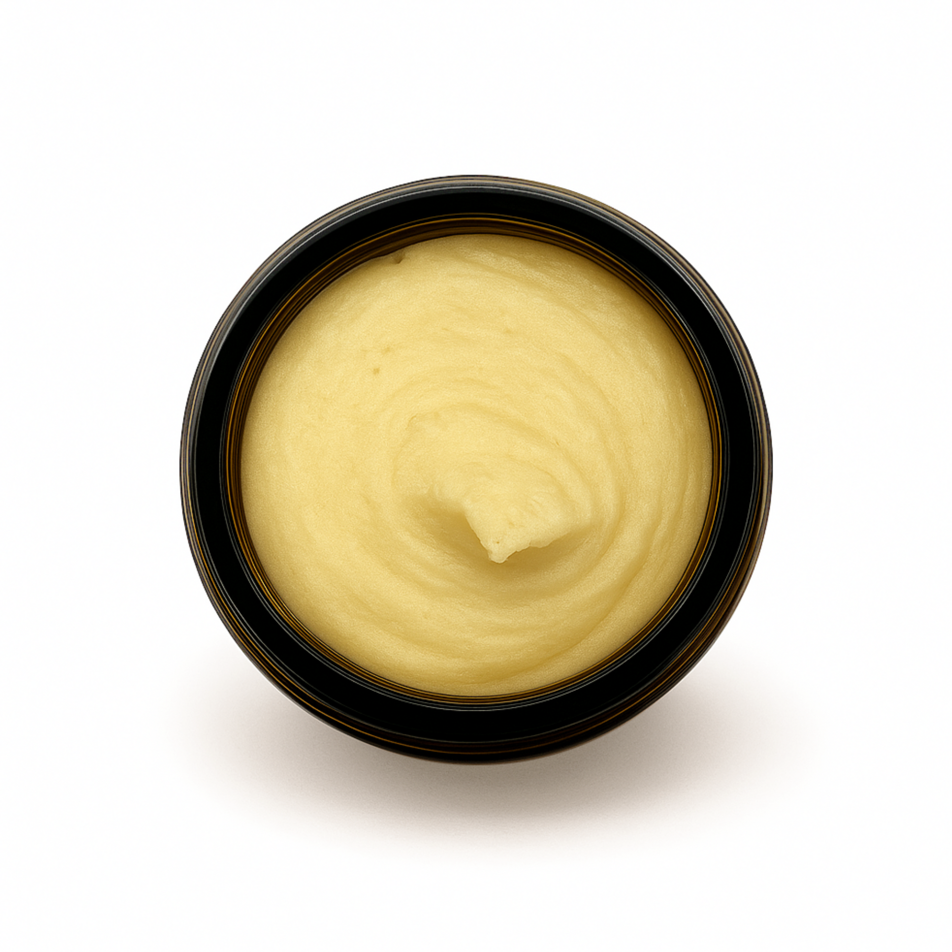 Top-down view of an open amber jar filled with whipped honey tallow balm for face & body, showing its smooth, creamy texture.